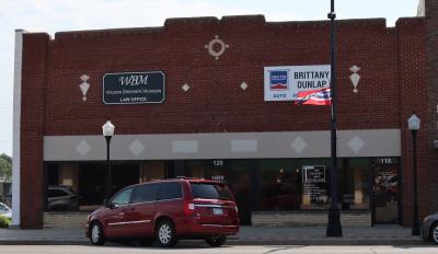 The building that once housed The Red Head Motor Company now houses a lawyers' office, realty company and a insurance agent.