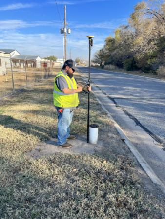 Kyle Irwin, Distribution & Collection Maintenance Worker I, demonstrates the Trimble GPS technology 